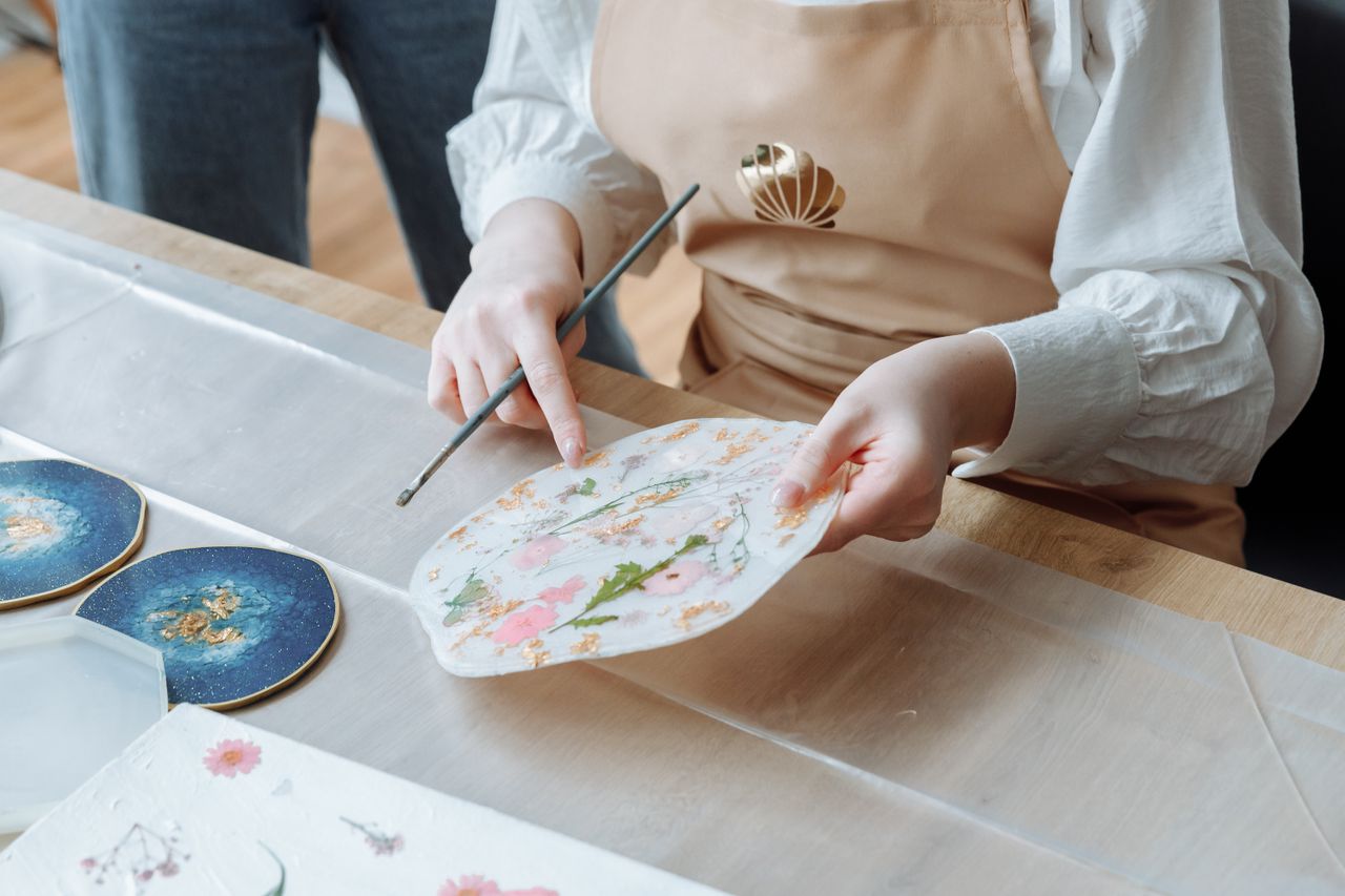 The Art of Drawing Readers In: Your attractive post title goes here Close-up view of a person painting art pieces in a studio with a focus on creativity and detail.