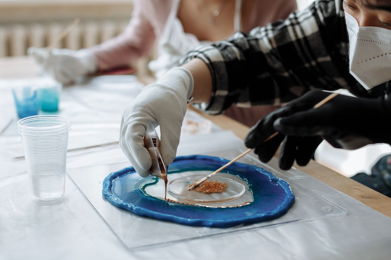 Crafting Captivating Headlines: Your awesome post title goes here Close-up of artists using resin and pigments for creating unique artwork.